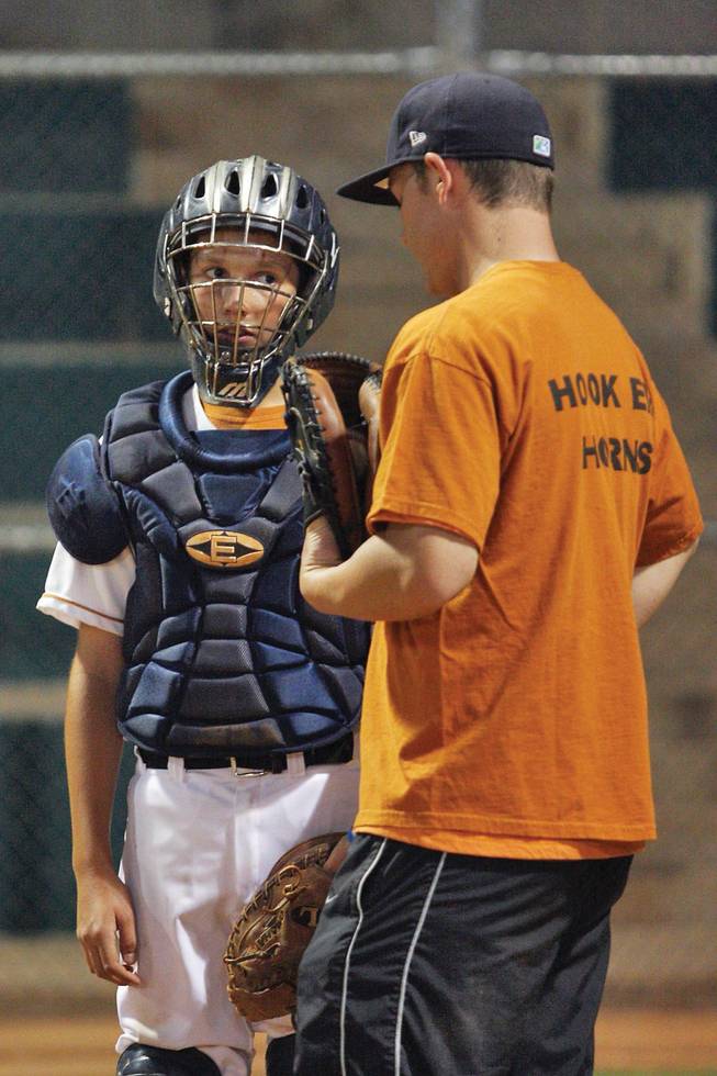 Alec Morrison, left, gets some suggestions from coach Kylee Hash of the Las Vegas Longhorns during practice at Burkholder Park on Sept. 30.