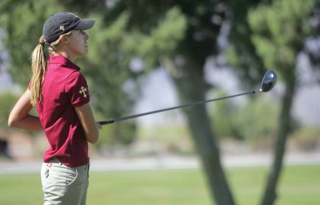 Faith Lutheran's Ashley Lacher watches as her ball flies through the air during the 3A Southern League golf tournament at the Boulder City Golf Course on Thursday.