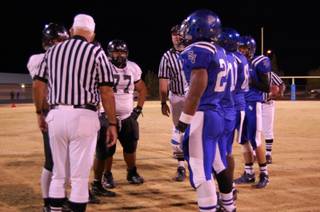 The Sierra Vista and Clark captains meet in the center for the coin toss before Friday night. 