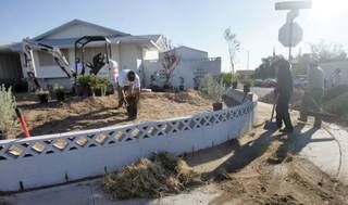 Working from early in the morning to late in the afternoon Oct. 21, landscapers renovate Janice Milton's yard and turn it into a beautiful garden. The Nevada State Contractors Board and the Nevada Landscape Association selected Milton, 90, as one of the two winners for the 