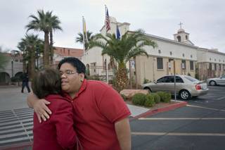 McCain supporter Kristopher Del Campo, hugs Myrna Adad outside St. Joseph Husband of Mary Roman Catholic Church on West Sahara after attending service at the start of his election day. 