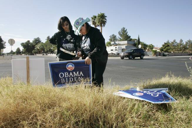 Precinct captain and chair of the Nevada Democratic Black Caucus Yvette Williams and her daughter Alyse Williams plant an Obama campaign sign. 