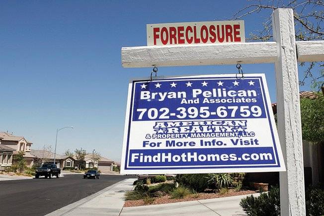 This sign in the northwest Las Vegas Valley is one indication Nevada's foreclosure rate leads the nation. A UNLV economist says the Las Vegas economy could be weak through 2010. 