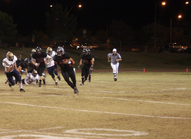 Las Vegas senior quarterback Emir Lopez (7) runs the ball for a first down during Friday's game against Foothill.