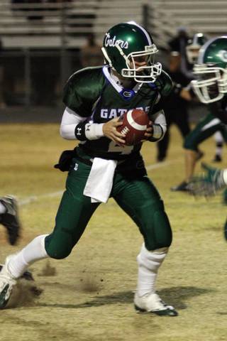 Green Valley quarterback Nick Libonati finds an open player to hand off the ball during Friday night's football game against Desert Pines at Green Valley High School.