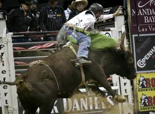 Bull riding at the final round of the PBR World Finals at the Thomas and Mack Center Sunday.  