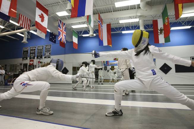 Dakota Root, 16, and Nik-Nik Ameli, 15, work on their foil techniques during fencing practice at the Fencing Academy of Nevada on Nov. 13. Root and Ameli will represent America at the Federation International fencing tournament in Germany and Austria.