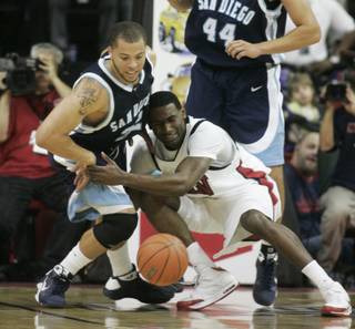 UNLV forward Darris Santee and San Diego forward Rob Jones fight for a loose ball during the first half of their game Saturday, Nov. 15, 2008.