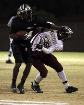 Palo Verde running back Sidney Hodge stiff-arms Cimarron-Memorial defensive back Roderick Washington during the Sunset Regional football semifinals at Palo Verde High School on Friday.
