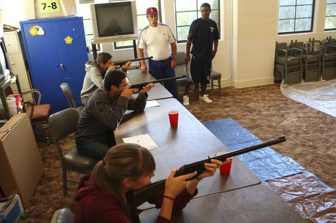 From bottom to top, siblings Ashley, Thomas and Richard Vince compete against each other Tuesday during the annual Turkey Shoot at the Boulder City Recreation Center. Watching from the side are parks and recreation employees Randy Shea and Jahmaka Gray, right.
 
