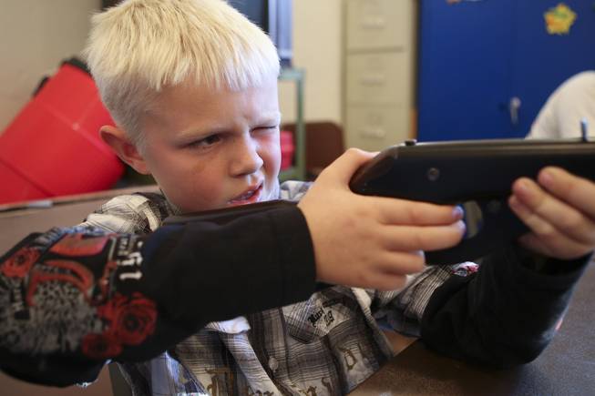Determined to hit the bulls eye, Foxx Dunar, 7, aims for his paper turkey while competing Tuesday in the annual Turkey Shoot at the Boulder City Recreation Center.