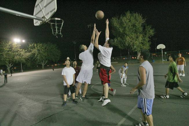 Players battle for a rebound during a pick-up game at the Sunset Park playgrounds.