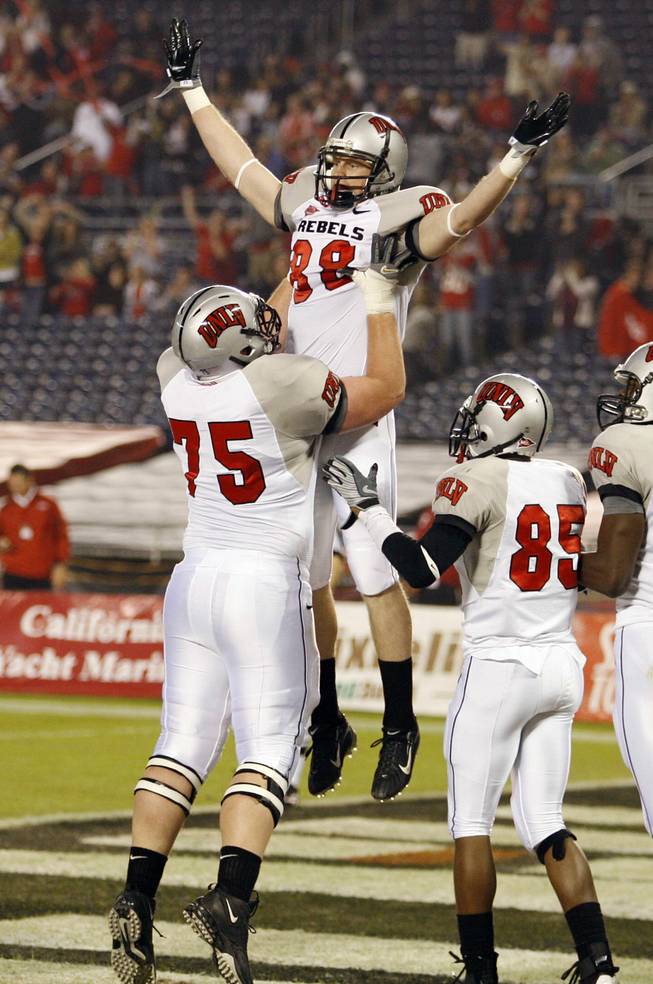 UNLV wide receiver Ryan Wolfe (88) is lifted by teammate Matt Murphy (75) after Wolfe scored a touchdown on a 33-yard pass reception, as Jerriman Robinson (85) looks on during the first quarter against San Diego State on Saturday, Nov. 22.