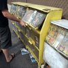 A man checks out a newsrack on the Strip near Spring Mountain Road containing magazines advertising female entertainers who will travel to homes and hotel rooms.