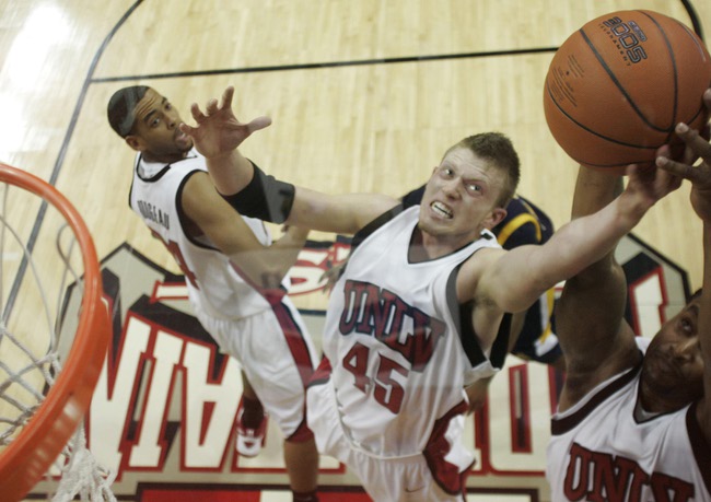 UNLV forward Joe Darger and guard Mareceo Rutledge grab for a defensive rebound during the second half of their game against North Carolina A&T Saturday at the Thomas & Mack Center. Darger finished with 18 points and four rebounds while Rutledge finished with five points and five boards. 
