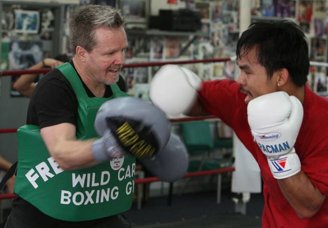 Roach, absorbing punches, says Pacquiao's speed will allow him to outmaneuver De La Hoya, a boxer Roach guided in a loss last year to Floyd Mayweather Jr.