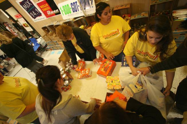 Volunteers from Wells Fargo sort through donations during the Four ...