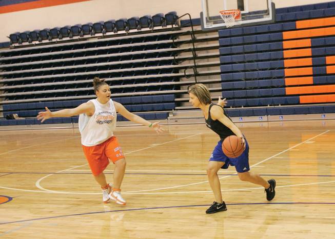 Bishop Gorman girls basketball coach Sheryl Krmpotich, right, and player Amiee Levine, 17, work on drills during practice.