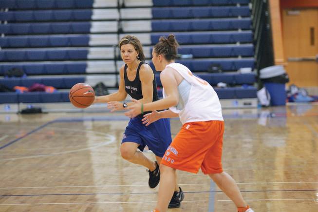 Bishop Gorman girls basketball coach Sheryl Krmpotich, left, and player Aimee Levine, 17, work on drills during practice .