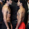 Oscar De La Hoya, left, and Manny Pacquiao face off Friday during the weigh-in at the MGM Grand Garden Arena for their 12-round welterweight fight today. Bernard Hopkins, the former middleweight champion, looks on at center.