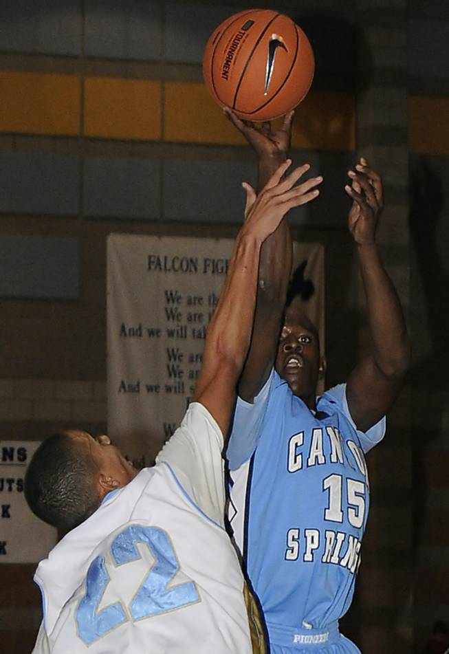 Canyon Springs guard Terrance Stanley looks to shoot over Falcons defender Evan Roquemore during the first half of a game at Foothill High School on Friday.