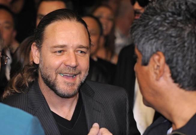 Actor Russell Crowe, left, greets comedian George Lopez prior to Oscar De La Hoya's welterweight boxing match against WBC lightweight champion Manny Pacquiao in Las Vegas on Saturday, Dec. 6, 2008.