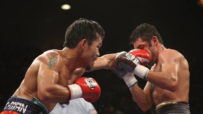 Manny Pacquiao of Philippines connects with Oscar De La Hoya of the U.S during their 'Dream Match' at the MGM Grand Garden Arena.