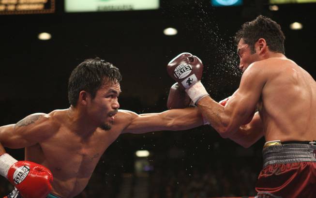 Manny Pacquiao connects with Oscar De La Hoya their 'Dream Match' at the MGM Grand Garden Arena on Saturday night. Pacquiao won with an eighth-round TKO.