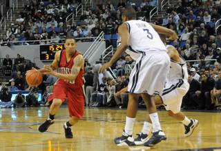 Tre'von Willis of UNLV drives it in against the UNR defense Saturday at the Lawlor Events Center in Reno.  UNLV defeated UNR 64-57.