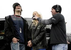 Criss Angel and Holly Madison were interviewed on KLUC 98.5 FM after they donated cash and dozens of toys to the station's annual toy drive. 