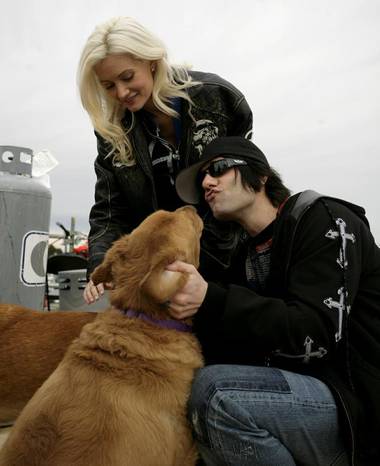 Criss Angel works his magic with another blonde at the 10th annual KLUC 98.5 FM toy drive, which benefits Help of Southern Nevada’s holiday toy assistance program.