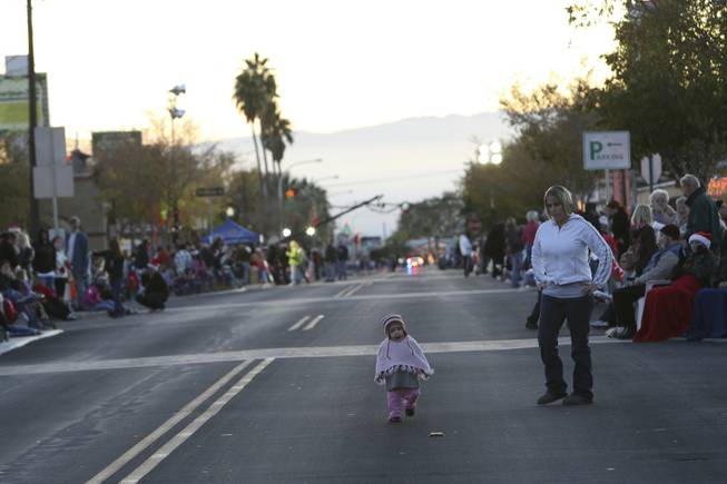 A toddler strolls down Nevada Way as her mom watches ...
