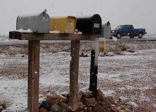 Mail boxes sit covered with snow along Blue Diamond Road Monday morning. 