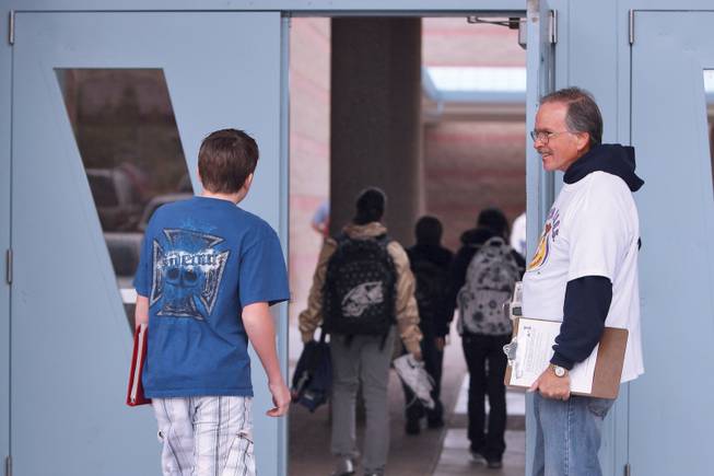As students arrive at school, Mike Cassidy greets them and monitors the entrance of Bob Miller Middle School as a volunteer with Watch D.O.G.S. Dads like Cassidy, whose sixth-grade son Vincent attends Bob Miller, volunteer at least one morning during the year as a way to offer the school another set of eyes and ears as crossing guards and campus monitors.