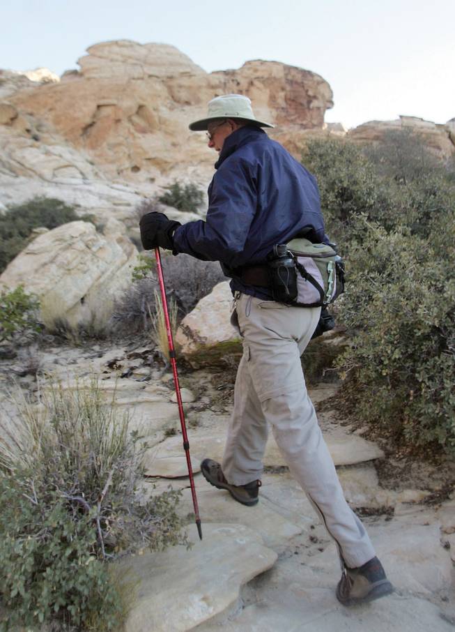 Chris Dempsey hikes along Sandstone Quarry at Red Rock Canyon on Dec. 9. Dempsey, who volunteers as a hike leader through Friends of Red Rock Canyon, was honored recently by the Bureau of Land Management for giving more than 1,000 volunteer hours.