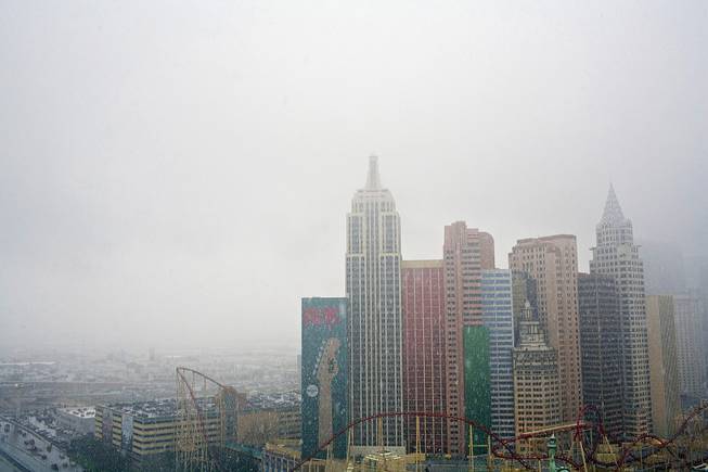 Snow comes down on the Las Vegas' New York New York, as seen from the roof of the Tropicana Hotel and Casino on Wednesday, Dec. 17, 2008. 