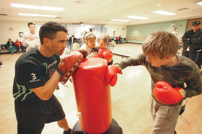 Luis Amelburu, left, boxes with sixth grader Billy Requme, who is visually impaired, during the year's final Paralympics Academy event Dec. 10 at the Henderson Multigenerational Center.