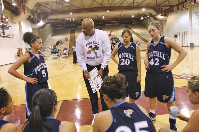 Foothill's girls basketball coach Keith Starr talks to his team during a time out during a game at Cimarron-Memorial.