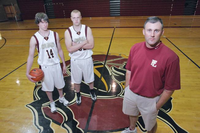 Faith Lutheran Athletic Director and basketball coach Bret Walter, right, poses inside the school's gym with players Chase Saunders, left, and Brett Lubbe. The school is being moved up to the 4A classification level so sports will be more competitive.