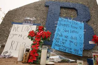 A makeshift memorial for Basic High school choir teacher Matthew Thomas Cox is seen outside Basic High.