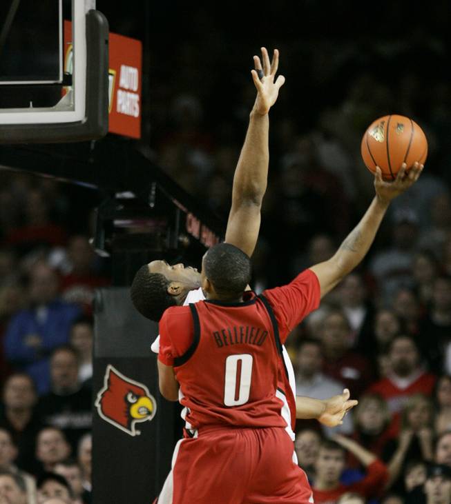 UNLV's Oscar Bellfield shoots over Louisville's Samardo Samuels for the winning basket in the closing seconds of the game in Louisville, Ky.  UNLV won 56-55. 