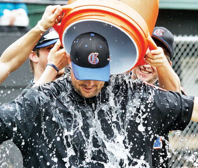 Bishop Gorman baseball coach Chris Sheff has water poured on him during the post game celebration after Gorman's Legion affiliate won the World Series.