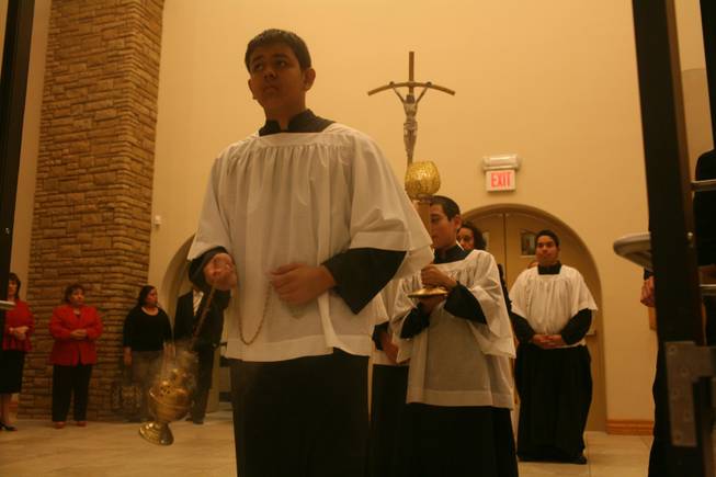 St. Bridget altar boy Marcos Mata leads the procession during a recent Spanish language service at the Catholic church near downtown Las Vegas. Once a small chapel that didn't serve many parishioners, St. Bridget a few years ago added a Spanish language Mass, which would become a force in the church's growth. In February the new church was dedicated, and Sundays now feature two Spanish language Masses and a Filipino service. Each Mass attracts hundreds of faithful.