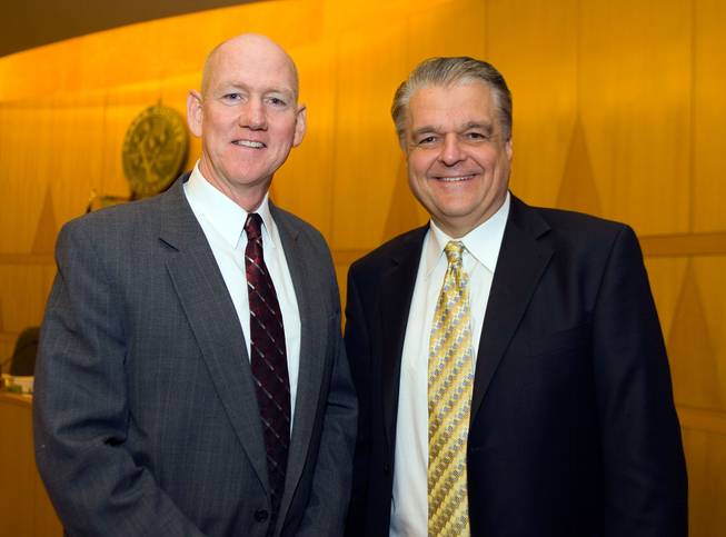 County commissioners Larry Brown, left, and Steve Sisolak pose for a portrait after Monday's swearing in ceremony at the Government Center in Las Vegas.