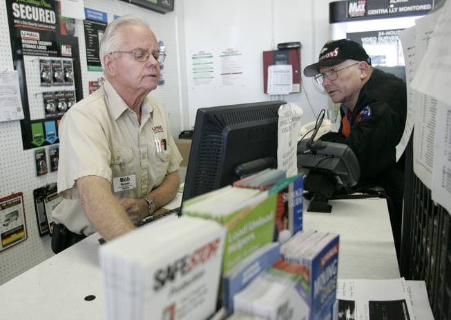 Bob Bower, left, checks on a truck at the U-Haul store Friday for Larry Rhodes, an airplane mechanic who says he's being transferred because travel is down.