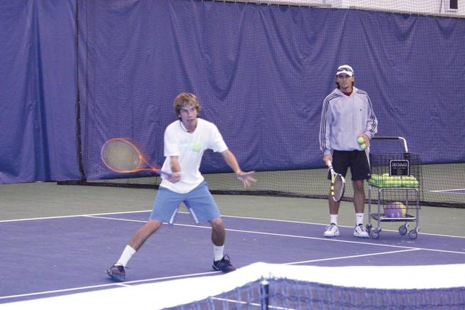 Andrew Rapahelson trains at the International Tennis Centre Las Vegas as tennis professional Henner Nehles looks on. Nehles, formerly a UNLV player, is the head pro at the facility, which opened Dec. 1.