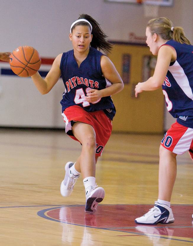 Liberty girls' basketball star Jade Washington drives against Phoebe Baker during practice at Liberty High School.