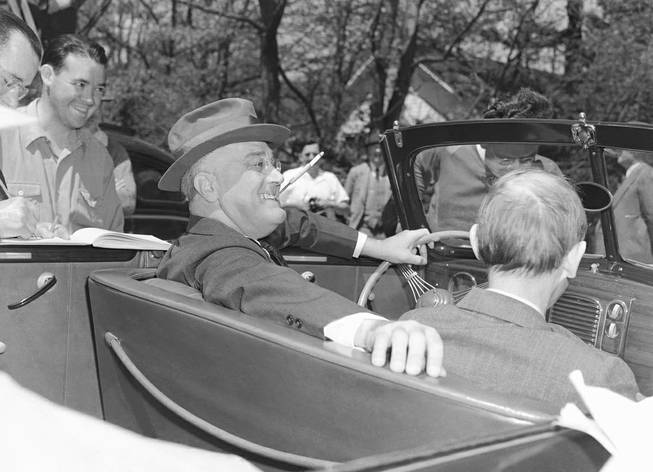 President Franklin Delano Roosevelt sits at the steering wheel of his vehicle in Warm Springs, Ga., on April 4, 1939. Time magazine played off the famous image for a November cover, at left, that featured President-elect Barack Obama.