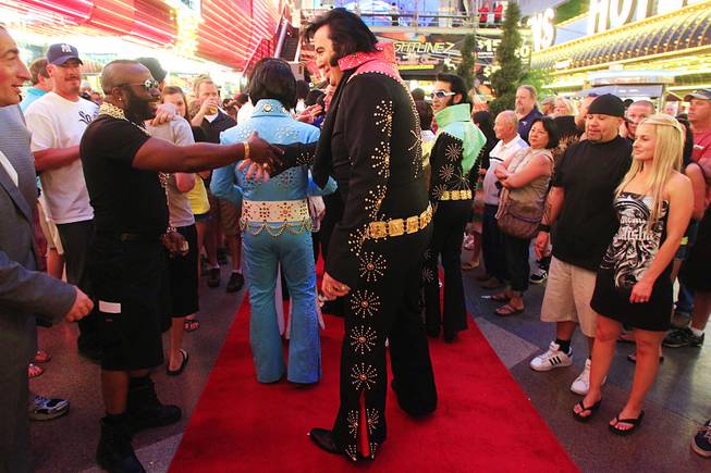 An Elvis tribute artist shakes hands with a Mr. T impersonator during the second annual Las Vegas Ultimate Elvis Tribute Artist Contest Friday, May 6, 2011 at the Fremont Street Experience. The winner of the contest will advance to the national contest to be held in Memphis in August.
