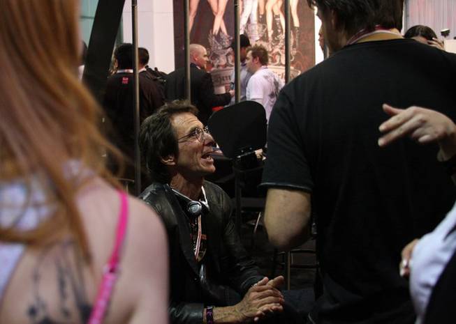 Porn director Jake Malone talks with friends during the four-day Adult Entertainment Expo in Las Vegas. 